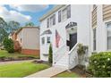 The home features a white painted brick facade with black shutters and a well-manicured lawn at 208 Hembree Park Ter, Roswell, GA 30076