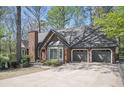 Attractive brick home with a three-car garage and well-manicured landscaping in a desirable neighborhood at 2689 Spring Rock Ne Ct, Roswell, GA 30075