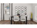 Dining room features a table with six chairs and modern decorative mirrors on the wall at 2810 Georgia Aster Nw Way # 6, Atlanta, GA 30318