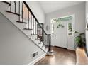 Inviting foyer with hardwood floors, staircase, and a bright white front door and sidelight windows at 170 Shelli Ln, Roswell, GA 30075