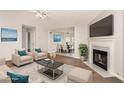 Bright living room featuring a cozy fireplace and view into the dining room, perfect for relaxation and entertaining at 350 Dailey Mill Rd, Mcdonough, GA 30253