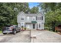 Inviting townhome with a driveway, lush trees, and charming curb appeal in a great neighborhood at 4098 Charlotte Se Ct, Smyrna, GA 30082