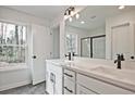 Bathroom with double vanity, quartz countertops and black hardware at 699 Sunstone Ln, Lawrenceville, GA 30043