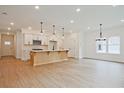 Bright, open-concept living space featuring hardwood floors and a modern island kitchen at 699 Sunstone Ln, Lawrenceville, GA 30043