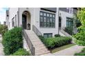 Close up of the exterior of this townhome featuring painted brick, a brick stairway, and black framed windows at 6399 Lucent Ln, Atlanta, GA 30328