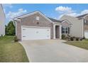 Charming brick home featuring a well-manicured lawn and a two-car garage for convenient parking at 2304 Pelham Pass, Dacula, GA 30019