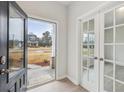 Inviting entryway showcasing French doors and views of the front yard at 3614 Squires Park Ln, Loganville, GA 30052