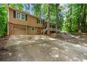Beautiful exterior showcasing the front yard, driveway, and an attached garage on a bright day at 4323 Japonica Sw Ct, Lilburn, GA 30047