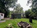 The backyard view features a firepit, sheds, and greenery, offering a glimpse of the outdoor space at 766 Warren Dr, Riverdale, GA 30296