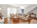 Bright living room with hardwood floors, neutral furniture, and a staircase, perfect for relaxation at 136 Peachtree Memorial Nw Dr # Ri2, Atlanta, GA 30309