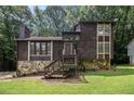 Charming two-story home with a stone foundation and lush greenery at 300 Twin Tendrils Sw, Atlanta, GA 30331