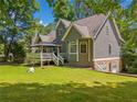 Home's backyard featuring well-maintained lawn and deck with gazebo and ground level garage at 507 Wintergreen Way, Canton, GA 30115