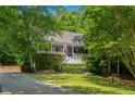 Charming home with a lush landscaped front yard, inviting porch and brick paved driveway at 507 Wintergreen Way, Canton, GA 30115