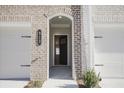 Close-up of the townhome's front door featuring stylish brickwork and the house number at 913 Agate Ln, Lawrenceville, GA 30043