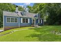 Charming blue two-story home with dormer windows and a well-maintained lawn and mature trees at 1046 S Mcdonough St, Decatur, GA 30030