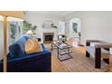 Bright living room with a cozy fireplace, comfortable seating, hardwood floors, and natural light at 1046 S Mcdonough St, Decatur, GA 30030