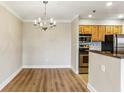 Open floor plan with wood floors and a chandelier; the dining area is adjacent to the updated kitchen at 300 Johnson Ferry Ne Rd # A811, Atlanta, GA 30328