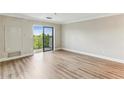 Living room with wood floors, bright light, and sliding glass doors leading to an outdoor balcony at 300 Johnson Ferry Ne Rd # A811, Atlanta, GA 30328