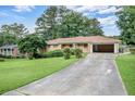 Ranch-style home with an attached garage and a long driveway at 3563 Carriage Way, East Point, GA 30344