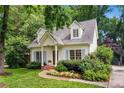 Charming cottage-style home with a well-manicured lawn,dormer windows, and inviting front porch at 999 Seaboard Nw Ave, Atlanta, GA 30318