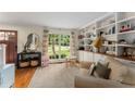 Living room featuring hardwood floors, built-in shelves, and lots of natural light at 999 Seaboard Nw Ave, Atlanta, GA 30318