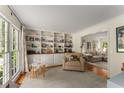 Bright living room with built-in bookshelves, hardwood floors, and large windows at 999 Seaboard Nw Ave, Atlanta, GA 30318