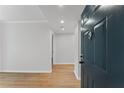 View from entryway with wood floors; a front door offers an inviting peek into a neutrally colored space with recessed lighting at 1280 W Peachtree Street Nw # 808, Atlanta, GA 30309