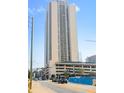Captured from the street, the image displays a tall condo building with a parking garage and nearby construction at 1280 W Peachtree Street Nw # 808, Atlanta, GA 30309