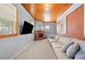 Cozy living room with a brick fireplace, exposed brick wall, and wood ceiling at 135 5Th Ave, Jonesboro, GA 30236