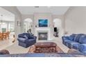 Comfortable living room featuring a fireplace, plush seating, and arched doorways that lead to adjacent rooms at 1530 Brisbane Dr, Dacula, GA 30019