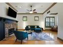 Comfortable living area with hardwood floors, stone fireplace, modern furniture, and natural light at 2822 Prado Ln, Marietta, GA 30066