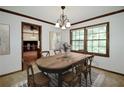Bright dining room featuring natural lighting, wood trim, a chandelier, and seating for six at 3409 Shorelake Dr, Tucker, GA 30084