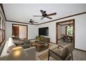 Cozy living room with two fans, wood trim, neutral colors, and ample space for relaxing and entertaining at 3409 Shorelake Dr, Tucker, GA 30084