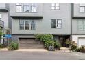 Townhome facade featuring gray siding, large windows, a two-car garage, and lush greenery at , Atlanta, GA 30315