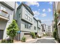 Townhome exterior featuring modern architecture, gray siding, and a two-car garage surrounded by green foliage at , Atlanta, GA 30315