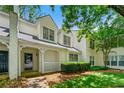 Two-story townhome with a charming entrance, complemented by well-maintained landscaping and inviting curb appeal at 1003 Cannongate Sw Xing, Marietta, GA 30064
