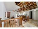 Spacious living area with a fireplace, exposed ceiling, and stairs, presenting an opportunity for renovation and design at 1003 Cannongate Sw Xing, Marietta, GA 30064