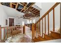Renovation opportunity: Spacious living area with stairs and exposed ceiling beams, awaiting restoration and customization at 1003 Cannongate Sw Xing, Marietta, GA 30064