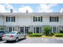 Exterior view of a two-story townhome with black shutters and well-manicured landscaping at 136 Peachtree Memorial Nw Dr # Pa4, Atlanta, GA 30309