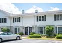 Exterior view of a two-story townhome with black shutters and well-manicured landscaping at 136 Peachtree Memorial Nw Dr # Pa4, Atlanta, GA 30309