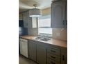 Kitchen features updated cabinets, new countertops, and stainless-steel appliances at 1631 Billy Bullock Rd, Dallas, GA 30157