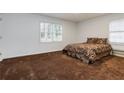 Spacious bedroom with neutral walls, carpeted floors, and natural light from the windows at 223 Dogwood Ln, Lawrenceville, GA 30046