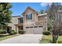 Charming two-story home featuring a stone front, attached two car garage and well-manicured lawn at 2780 Lakeview Walk, Decatur, GA 30035