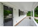 Relaxing porch with wood flooring and fresh, white paint and black shutters at 2923 Bicentennial Dr, Stone Mountain, GA 30087