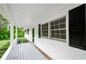 Inviting outdoor porch with white railings and black shutters, perfect for relaxing at 2923 Bicentennial Dr, Stone Mountain, GA 30087