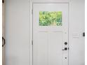 Interior view of a white paneled door featuring a window to the outside at 4020 Ester Sw Dr, Atlanta, GA 30331