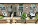 Aerial view of brick townhouses featuring fenced-in patios and covered front entrances at 6980 Roswell Rd # P6, Atlanta, GA 30328
