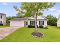 Charming home with a well-kept lawn, attached garage, and classic black shutters at 102 Natalie Ct, Dallas, GA 30157