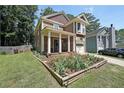 Inviting two-story home with a front garden, a well-kept lawn, and a cozy front porch at 1313 Old Countryside Cir, Stone Mountain, GA 30083