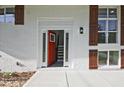 Eye-catching front entrance with vibrant orange door, sidelights and brown shutters around the white frame at 1349 Heather Cir, Riverdale, GA 30296
